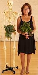 woman standing with skeleton holding veggies