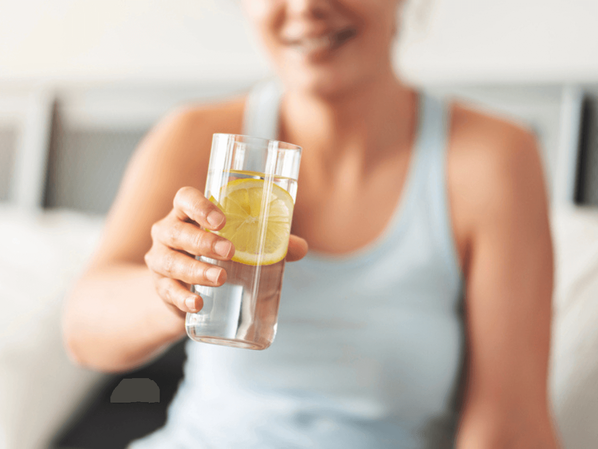 Woman Holding a Glass of Water with Lemon