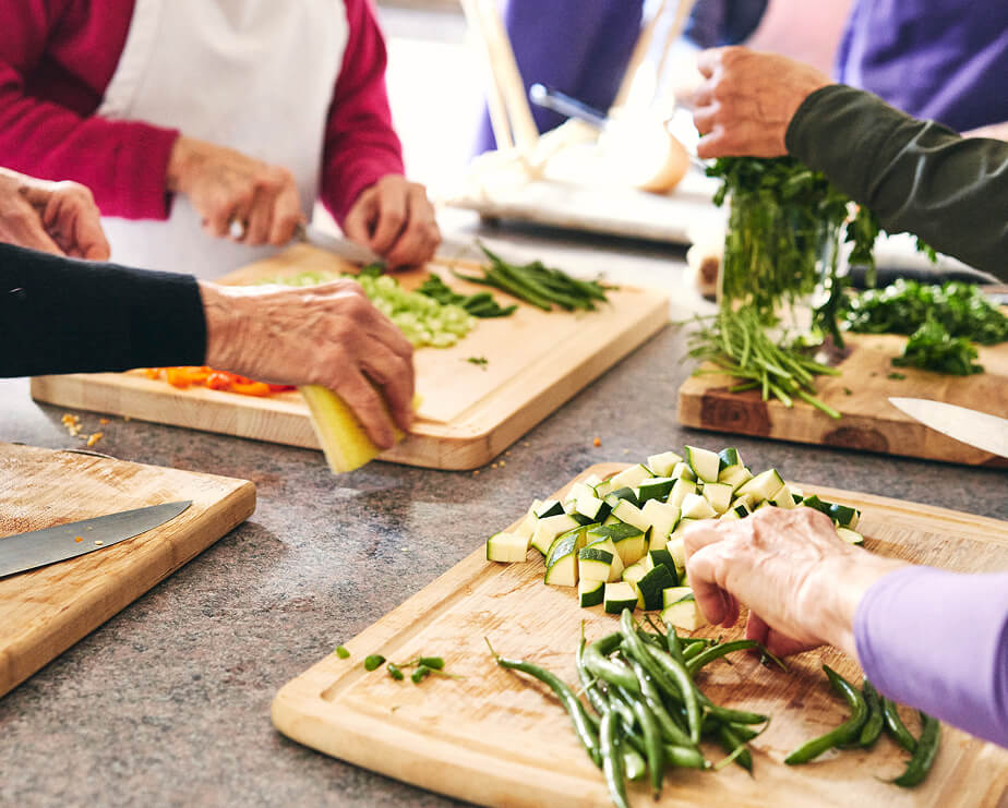 Women cutting vegetables